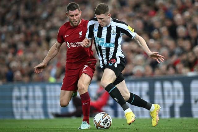Newcastle United's English midfielder Elliot Anderson (R) vies with Liverpool's English midfielder James Milner (L) during the English Premier League football match between Liverpool and Newcastle United at Anfield in Liverpool, north west England on August 31, 2022.  (Photo by PAUL ELLIS/AFP via Getty Images)