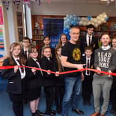 Author Dan Smith alongside Hebburn Comprehensive School's pupils and librarian, Liam Owens, at the official opening of the school's new library.