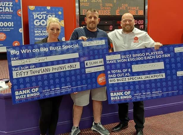 Jeff Short collecting his winnings at Buzz Bingo