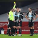 LONDON, ENGLAND - JANUARY 09: Andy Carroll of Newcastle United is shown a yellow card by Referee Chris Kavanagh during the FA Cup Third Round match between Arsenal and Newcastle United at Emirates Stadium on January 09, 2021 in London, England. The match will be played without fans, behind closed doors as a Covid-19 precaution. (Photo by Julian Finney/Getty Images)