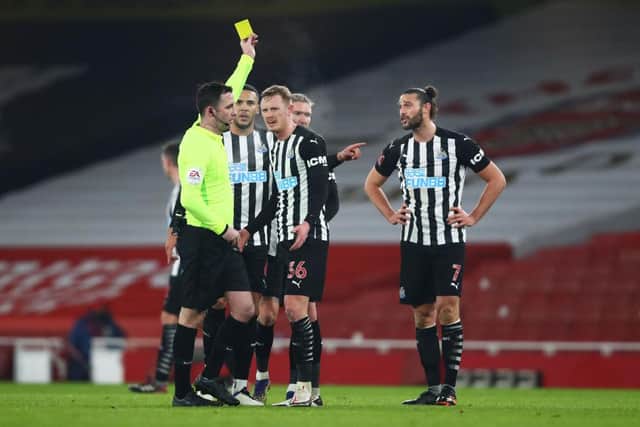 LONDON, ENGLAND - JANUARY 09: Andy Carroll of Newcastle United is shown a yellow card by Referee Chris Kavanagh during the FA Cup Third Round match between Arsenal and Newcastle United at Emirates Stadium on January 09, 2021 in London, England. The match will be played without fans, behind closed doors as a Covid-19 precaution. (Photo by Julian Finney/Getty Images)