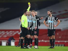 LONDON, ENGLAND - JANUARY 09: Andy Carroll of Newcastle United is shown a yellow card by Referee Chris Kavanagh during the FA Cup Third Round match between Arsenal and Newcastle United at Emirates Stadium on January 09, 2021 in London, England. The match will be played without fans, behind closed doors as a Covid-19 precaution. (Photo by Julian Finney/Getty Images)