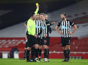 LONDON, ENGLAND - JANUARY 09: Andy Carroll of Newcastle United is shown a yellow card by Referee Chris Kavanagh during the FA Cup Third Round match between Arsenal and Newcastle United at Emirates Stadium on January 09, 2021 in London, England. The match will be played without fans, behind closed doors as a Covid-19 precaution. (Photo by Julian Finney/Getty Images)