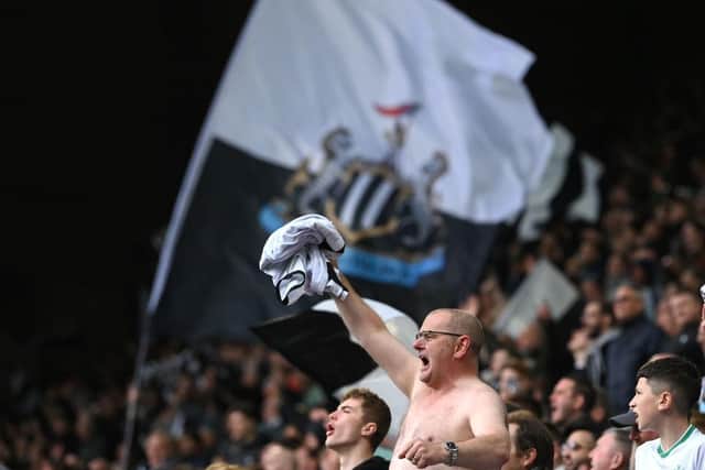 Newcastle United fans celebrate the Tottenham Hotspur win.