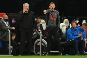 NEWCASTLE UPON TYNE, ENGLAND - OCTOBER 17: Newcastle manager Steve Bruce (l) with coach Graeme Jones on the touchline during the Premier League match between Newcastle United and Tottenham Hotspur at St. James Park on October 17, 2021 in Newcastle upon Tyne, England. (Photo by Stu Forster/Getty Images)