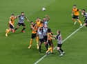NEWCASTLE UPON TYNE, ENGLAND - FEBRUARY 27: Jonjo Shelvey and Jamaal Lascells of Newcastle battle with Romaine Saiss of Wolves as a corner comes in during the Premier League match between Newcastle United and Wolverhampton Wanderers at St. James Park on February 27, 2021 in Newcastle upon Tyne, England.