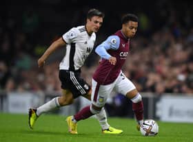Cameron Archer of Aston Villa runs ahead of Joao Palhinha of Fulham during a Premier League match.