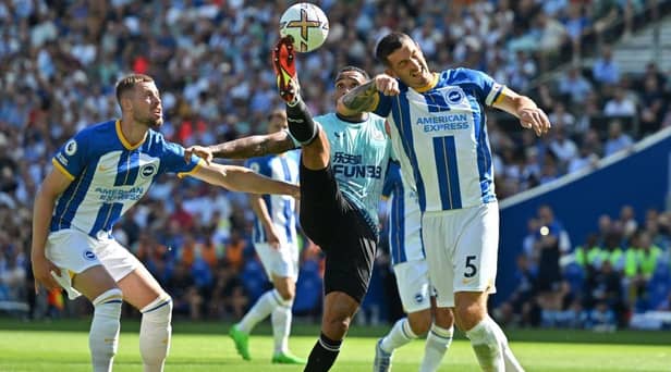 Newcastle United's English striker Callum Wilson (C) vies with Brighton's English defender Adam Webster (L) and Brighton's English defender Lewis Dunk (R) during the English Premier League football match between Brighton and Hove Albion and Newcastle United at the American Express Community Stadium in Brighton, southern England on August 13, 2022.Photo by GLYN KIRK/AFP via Getty Images)