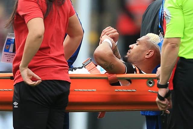 Newcastle United midfielder Joelinton is stretchered off.