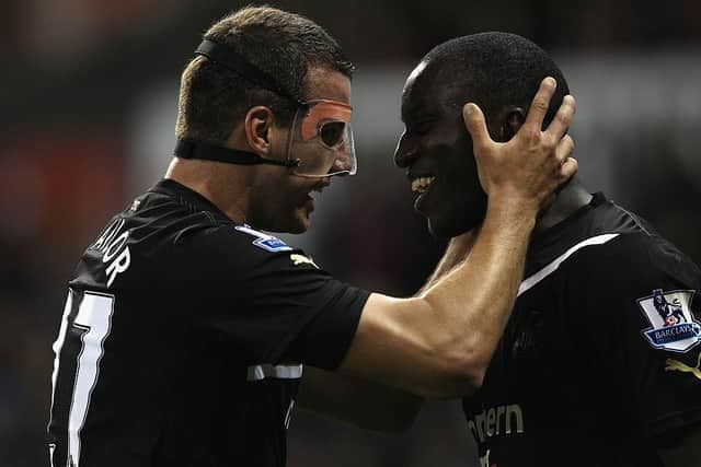 Demba Ba celebrates scoring against Stoke City in 2011 with Steven Taylor.