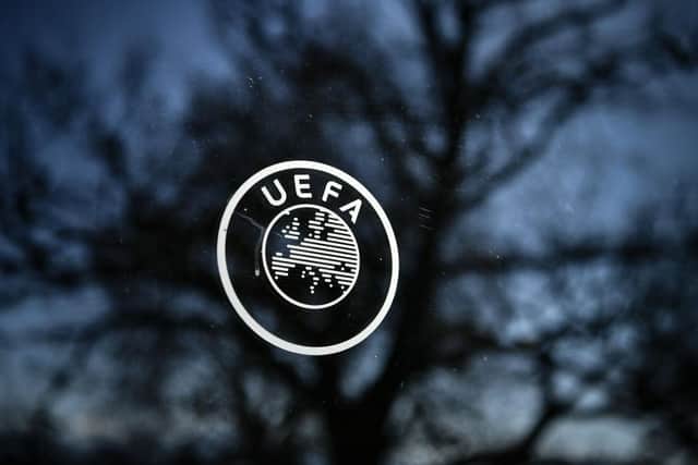 A picture taken on February 28, 2020 shows a UEFA sign through a window at the headquarters of the European football's governing body in Nyon. (Photo by FABRICE COFFRINI / AFP) (Photo by FABRICE COFFRINI/AFP via Getty Images)