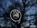 A picture taken on February 28, 2020 shows a UEFA sign through a window at the headquarters of the European football's governing body in Nyon. (Photo by FABRICE COFFRINI / AFP) (Photo by FABRICE COFFRINI/AFP via Getty Images)