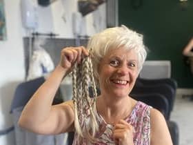 Jane Mills with the 13 inches of hair she gave up for charity at The Hairdresser on the Corner.