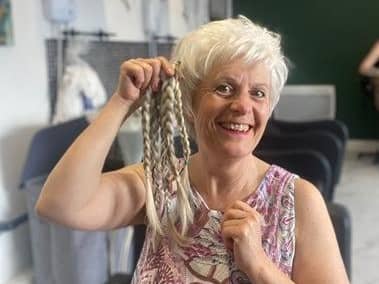 Jane Mills with the 13 inches of hair she gave up for charity at The Hairdresser on the Corner.