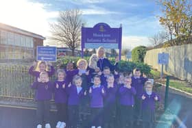 The School Council, Clare Askwith (Headteacher) and Rosie (the school dog) celebrate being 'Good' in all areas.