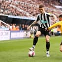 NEWCASTLE UPON TYNE, ENGLAND - MARCH 12: Kieran Trippier of Newcastle United battles for possession with Daniel Podence of Wolverhampton Wanderers during the Premier League match between Newcastle United and Wolverhampton Wanderers at St. James Park on March 12, 2023 in Newcastle upon Tyne, England. (Photo by Naomi Baker/Getty Images)
