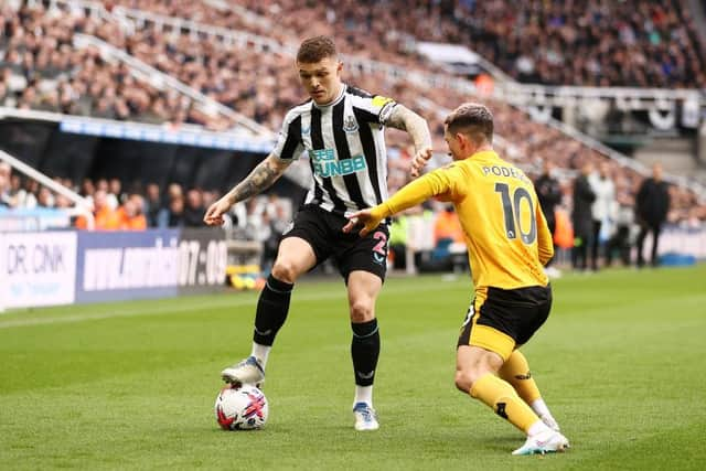 NEWCASTLE UPON TYNE, ENGLAND - MARCH 12: Kieran Trippier of Newcastle United battles for possession with Daniel Podence of Wolverhampton Wanderers during the Premier League match between Newcastle United and Wolverhampton Wanderers at St. James Park on March 12, 2023 in Newcastle upon Tyne, England. (Photo by Naomi Baker/Getty Images)