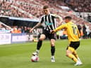 NEWCASTLE UPON TYNE, ENGLAND - MARCH 12: Kieran Trippier of Newcastle United battles for possession with Daniel Podence of Wolverhampton Wanderers during the Premier League match between Newcastle United and Wolverhampton Wanderers at St. James Park on March 12, 2023 in Newcastle upon Tyne, England. (Photo by Naomi Baker/Getty Images)