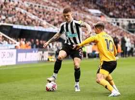NEWCASTLE UPON TYNE, ENGLAND - MARCH 12: Kieran Trippier of Newcastle United battles for possession with Daniel Podence of Wolverhampton Wanderers during the Premier League match between Newcastle United and Wolverhampton Wanderers at St. James Park on March 12, 2023 in Newcastle upon Tyne, England. (Photo by Naomi Baker/Getty Images)