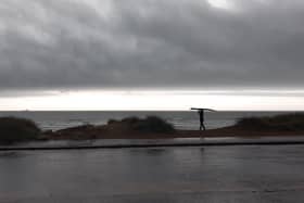 A surfer braves the waves at Sandhaven Beach, in South Shields, despite the wet and windy weather.