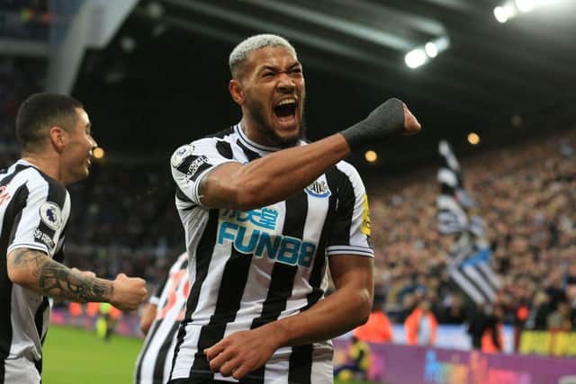 Newcastle United's Brazilian striker Joelinton (centre right) celebrates after scoring their third goal during the English Premier League football match between Newcastle United and Aston Villa at St James' Park in Newcastle-upon-Tyne, north east England on October 29, 2022. (Photo by LINDSEY PARNABY/AFP via Getty Images)