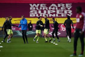 Newcastle United's English-born Northern Irish defender Jamal Lewis (C-L) and Newcastle United's English striker Andy Carroll (C-R) warm up prior to the English Premier League football match between Burnley and Newcastle United at Turf Moor in Burnley, north west England on April 11, 2021.