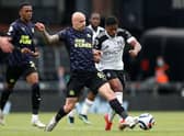 Jonjo Shelvey of Newcastle United tackles Ivan Cavaleiro of Fulham.