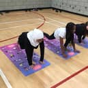 Children at Laygate Community School taking part in a yoga class.