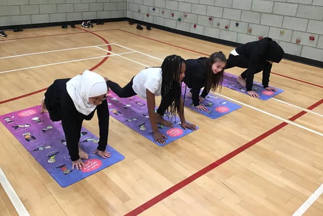Children at Laygate Community School taking part in a yoga class.