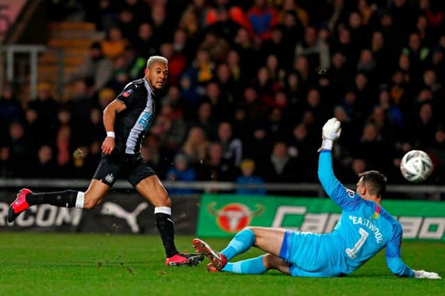 Newcastle United's Brazilian striker Joelinton (L) shoots past Oxford United's English goalkeeper Simon Eastwood to score their second goal during the FA Cup fourth round replay football match between Oxford United and Newcastle United at the Kassam Stadium in Oxford, west of London, on February 4, 2020.