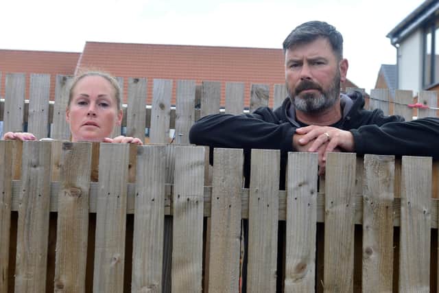 Garden Gate Drive residents Lee and Mel Taylor are unhappy with different fence heights with neighbours