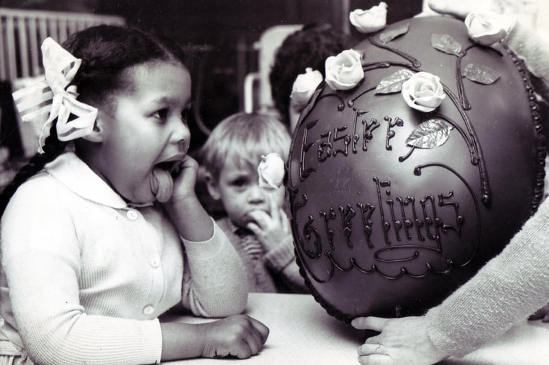 Licking her lips in anticipation of the forthcoming feast is four-year-old Patricia Wells, one of the patients of the Sheffield Children's Hospital, who helped to dispose of this giant Easter egg presented to the hospital by Sheffield department store, John Walsh in March 1967