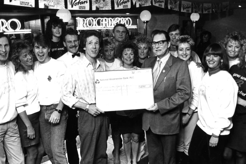 Byron Ross, proprietor of the Trocadero, presents a cheque for £2,000 to Ron Drew, chairman of the Scanner Appeal. Members of staff look on but who can tell us more about this 1987 event?