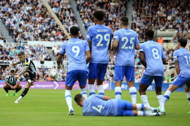 Newcastle United's English defender Kieran Trippier (2L) takes a free kick after a foul on Newcastle United's Brazilian midfielder Bruno Guimaraes during the English Premier League football match between Newcastle United and AFC Bournemouth at St James' Park in Newcastle-upon-Tyne, north east England on September 17, 2022. (Photo by LINDSEY PARNABY/AFP via Getty Images)