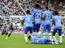 Newcastle United's English defender Kieran Trippier (2L) takes a free kick after a foul on Newcastle United's Brazilian midfielder Bruno Guimaraes during the English Premier League football match between Newcastle United and AFC Bournemouth at St James' Park in Newcastle-upon-Tyne, north east England on September 17, 2022. (Photo by LINDSEY PARNABY/AFP via Getty Images)