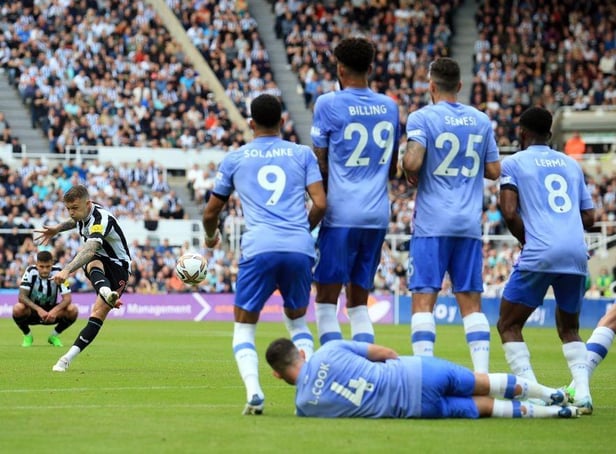 Newcastle United's English defender Kieran Trippier (2L) takes a free kick after a foul on Newcastle United's Brazilian midfielder Bruno Guimaraes during the English Premier League football match between Newcastle United and AFC Bournemouth at St James' Park in Newcastle-upon-Tyne, north east England on September 17, 2022. (Photo by LINDSEY PARNABY/AFP via Getty Images)