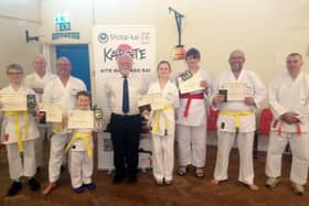 Shotai Kai Wado Ryu Karate Club chief instructor Larry Inskip with students celebrating passing a grading.