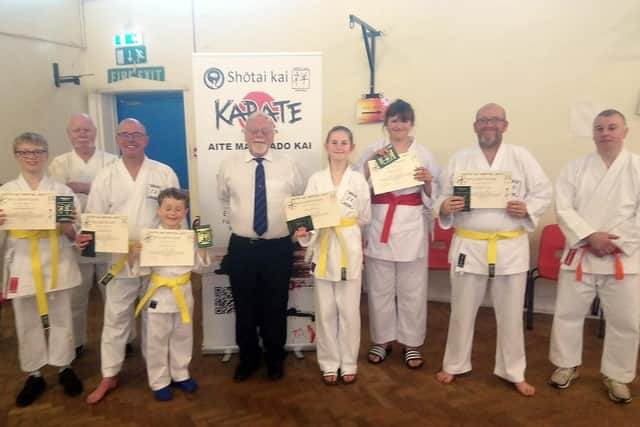 Shotai Kai Wado Ryu Karate Club chief instructor Larry Inskip with students celebrating passing a grading.