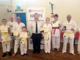 Shotai Kai Wado Ryu Karate Club chief instructor Larry Inskip with students celebrating passing a grading.