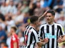 Newcastle United's Swiss defender Fabian Schar (R) celebrates with Newcastle United's English defender Kieran Trippier (L) after scoring his team first goal during the English Premier League football match between Newcastle United and Nottingham Forest at St James' Park in Newcastle-upon-Tyne, north east England on August 6, 2022.  (Photo by NIGEL RODDIS/AFP via Getty Images)