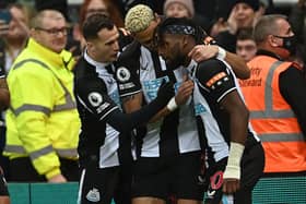 Newcastle United's French midfielder Allan Saint-Maximin (R) celebrates with teammates after scoring the opening goal of the English Premier League football match between Newcastle United and Manchester United at St James' Park(Photo by Paul ELLIS / AFP)