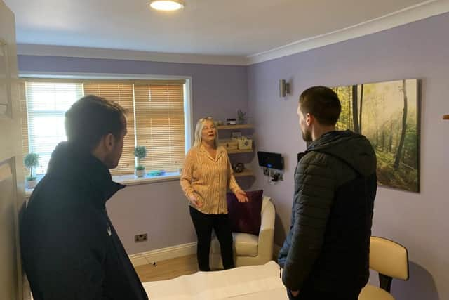 Deborah Roberts shows Blair Adams and Jon Shaw around the Cancer Connections facility