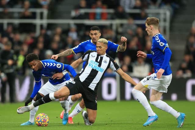 Newcastle United's Brazilian striker Joelinton (C) vies with Everton's English striker Demarai Gray (L), Everton's Brazilian midfielder Allan (2nd L) and Everton's English striker Anthony Gordon (R) during the English Premier League football match between Newcastle United and Everton at St James' Park in Newcastle-upon-Tyne, north east England on February 8, 2022.  (Photo by LINDSEY PARNABY/AFP via Getty Images)