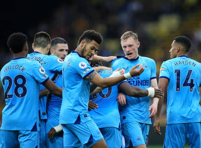 WATFORD, ENGLAND - SEPTEMBER 25: Sean Longstaff of Newcastle United celebrates scoring his sides first goal with team mates during the Premier League match between Watford and Newcastle United at Vicarage Road on September 25, 2021 in Watford, England. (Photo by Stephen Pond/Getty Images)