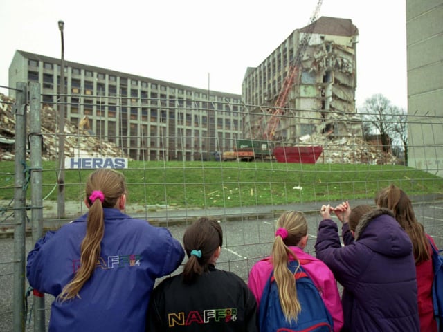 Children watching the old Westburn blocks of flats being demolished at Wester Hailes, Edinburgh. Picture taken January 1993.