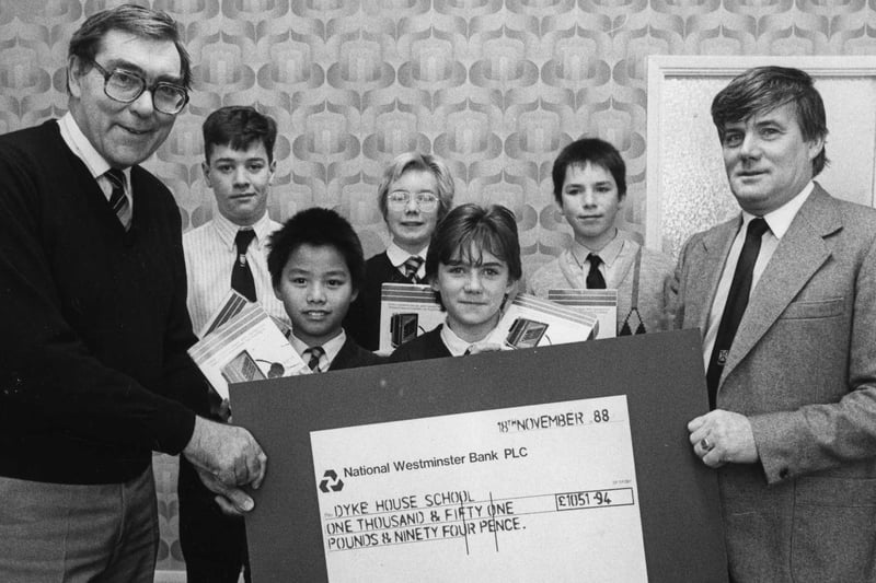 Hughie Hamilton (right), chairman of the Dyke House Parent Teachers Association, hands over a cheque for £1,051.94 to school headmaster P Ramsden from the proceeds of a sponsored run from Seaton Carew to the school.  Pictured are pupils, Colin Aisbitt, Hing Kai Lieu, Emily Allen, Sarah Campbell and Darren Lowry.
