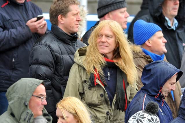 Iron Maiden guitarist Janick Gers, centre, pictured at a Hartlepool United game.