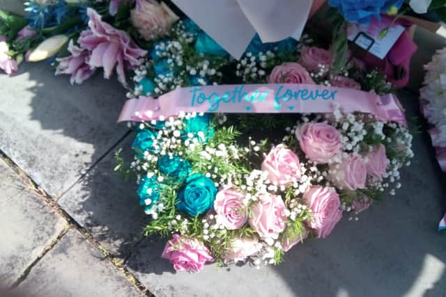 Pink and blue flowers left at the Chloe and Liam Together Forever bench outside of South Shields Town Hall.