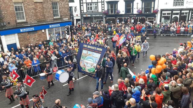 A pipe band leads the Fire Brigades Union's North East region banner as it is paraded at last weekend's Durham Miners' Gala.