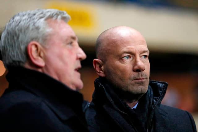 Newcastle United's English head coach Steve Bruce (L) checks out the pitch conditions with former player and manager of Newcastle, Alan Shearer (R) ahead of the FA Cup fourth round replay football match between Oxford United and Newcastle United at the Kassam Stadium in Oxford, west of London, on February 4, 2020.